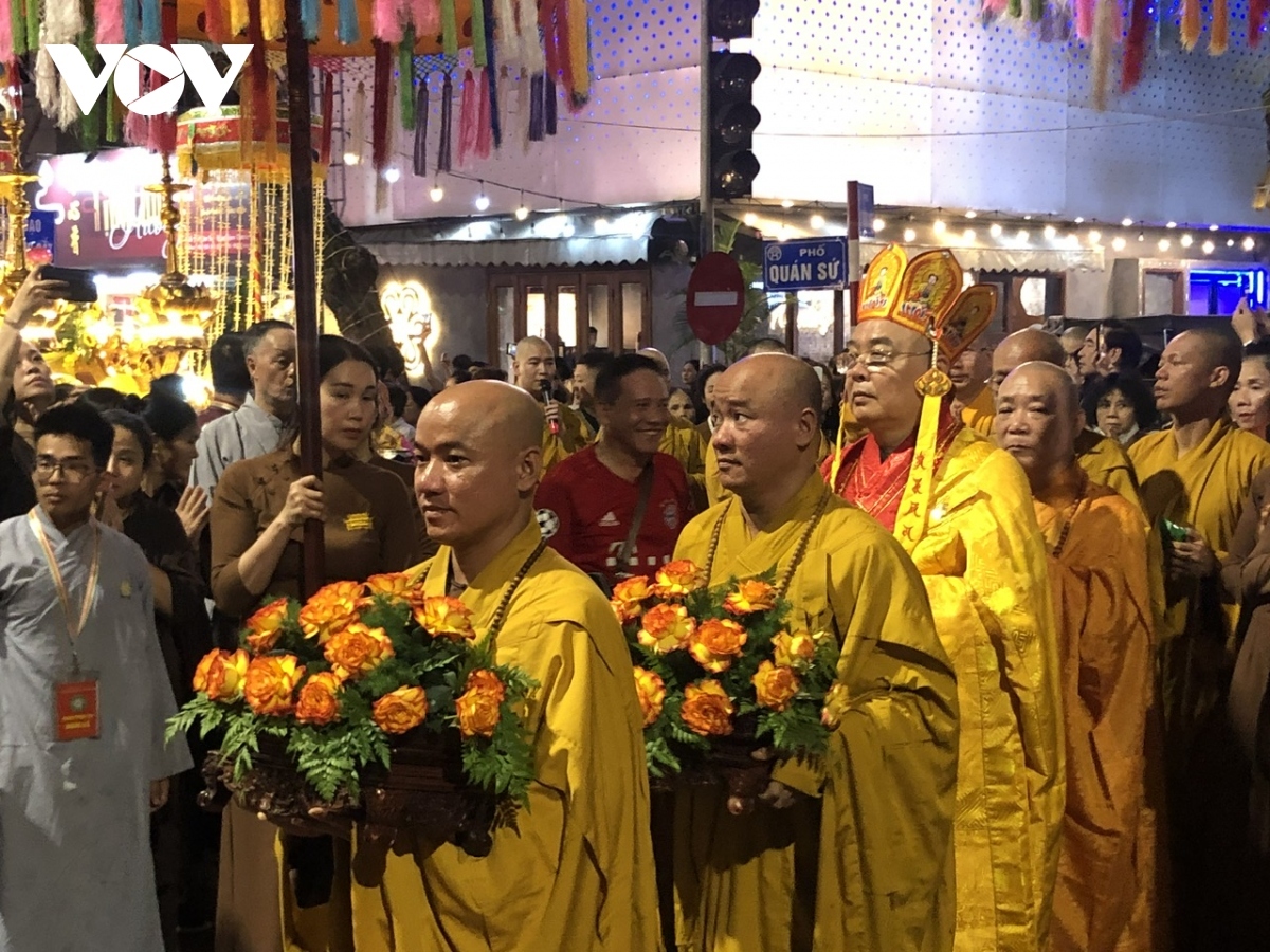 Buddhist dignitaries, monks, nuns, and followers offer incense to Lord Buddha and chant Buddhist scriptures.