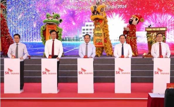 Deputy Prime Minister Tran Luu Quang (C) and other delegates push button to start work on Ecovance high-tech biodegradable materials factory