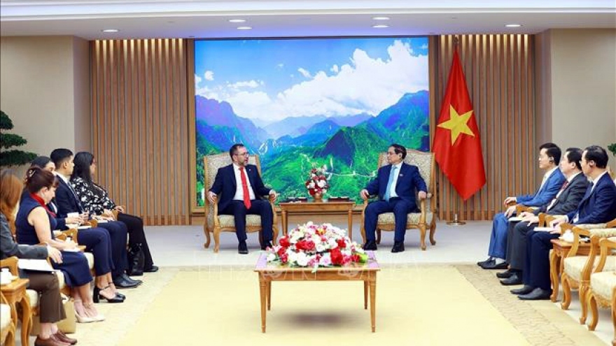 Vietnamese Prime Minister Pham Minh Chinh (R) receives Venezuelan Minister of Foreign Affairs Yvan Gil Pinto in Hanoi on June 8