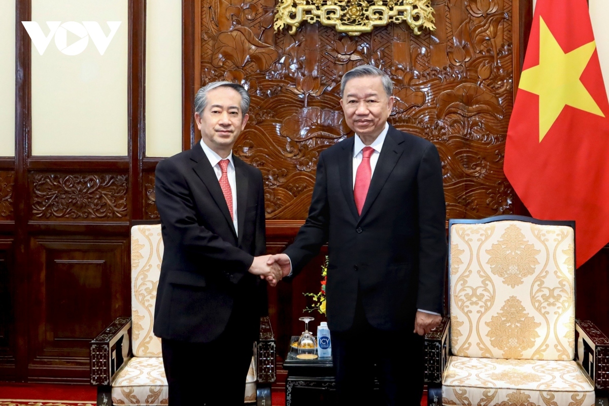 Newly elected President To Lam (R) shaking hands with Chinese Ambassador to Vietnam Xiong Bo ahead of their meeting in Hanoi on June 11