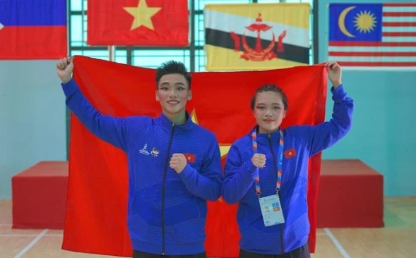 Pencak Silat athletes - Hoang Linh Dan (right) and Nguyen Thanh Long - win two gold medals in Seni events (performance) at the ongoing 13th ASEAN School Games (ASG) in the central city of Da Nang.