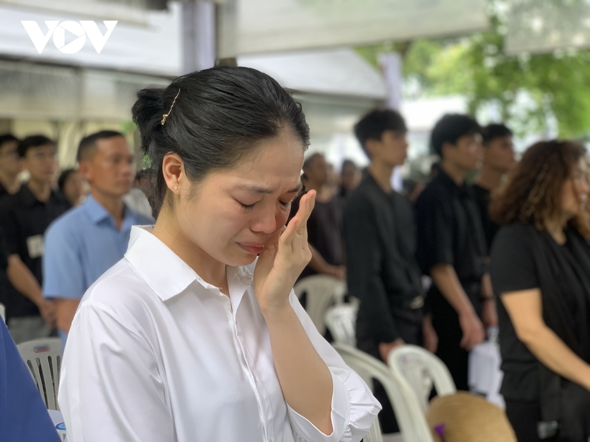 Residents are moved to tears while watching the memorial service and funeral procession for the Party leader at the National Funeral Hall in Hanoi on a TV screen