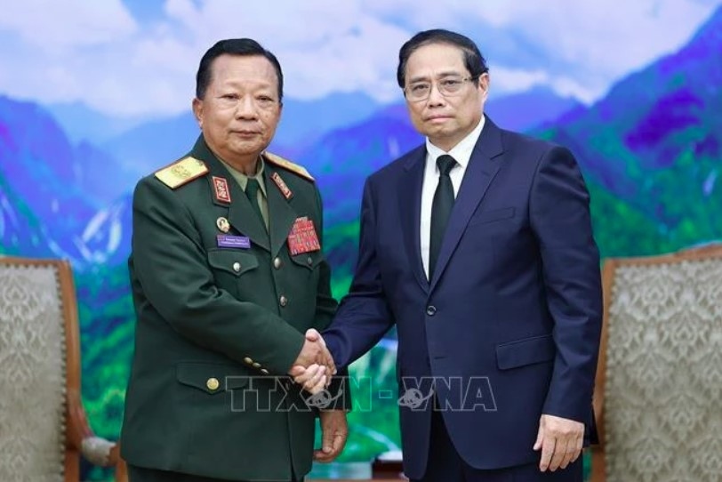 PM Pham Minh Chinh (right) receives General Chansamone Chanyalath, Deputy PM and Minister of National Defence of Laos, in Hanoi on July 25. (Photo: VNA)