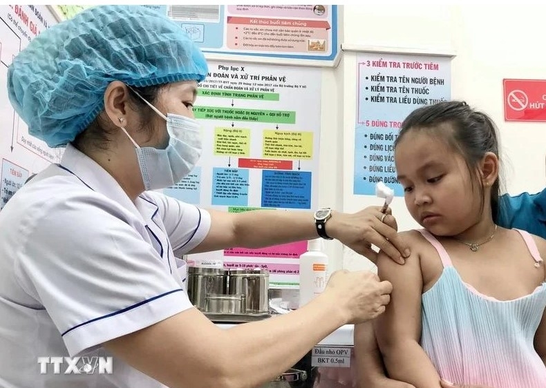 A kid gets measles jab at An Lac ward medical station in Binh Tan district.
