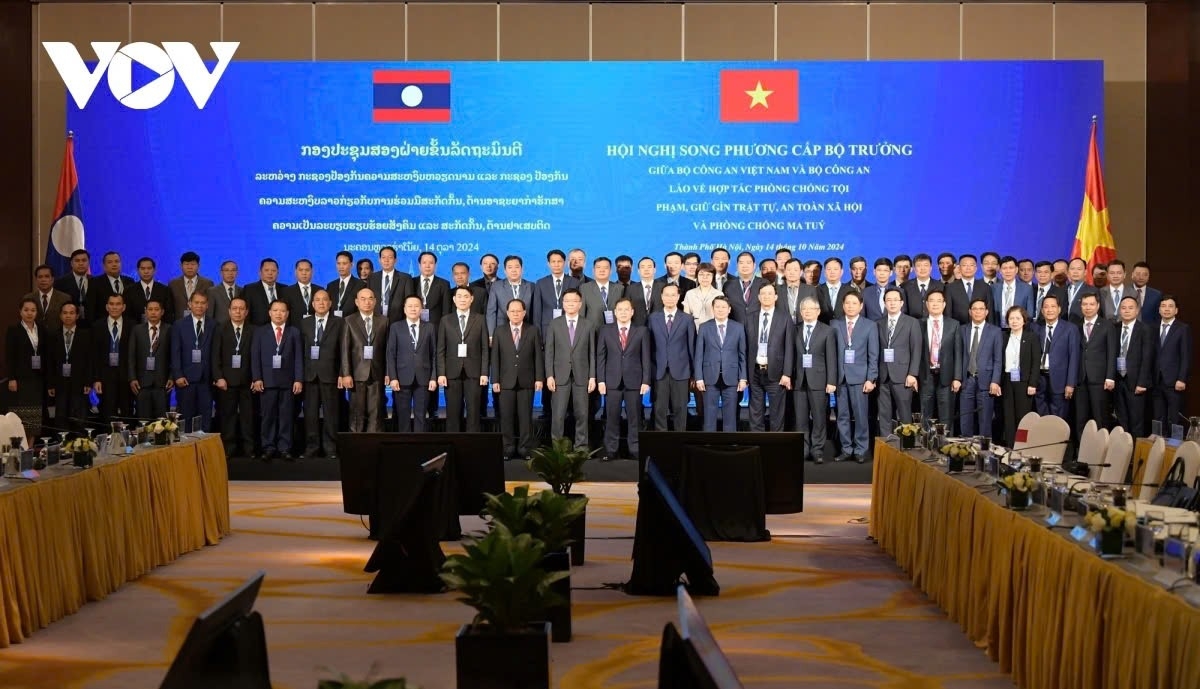 Delegates to the meeting pose for a group photo in Hanoi on October 14