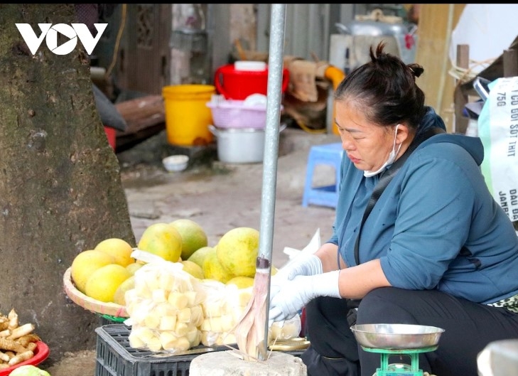 A street vendor works hard amid the chilly weather conditions.