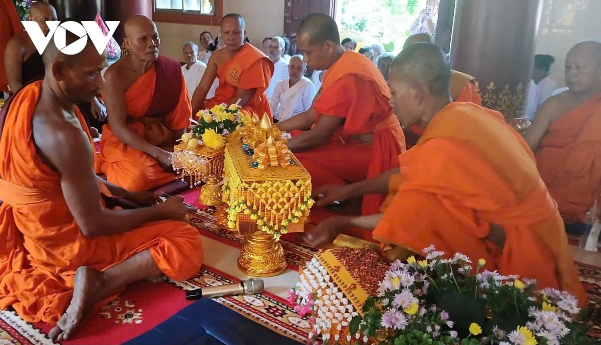 The monks are preparing to open the box containing the robes offered by the Buddhist followers.