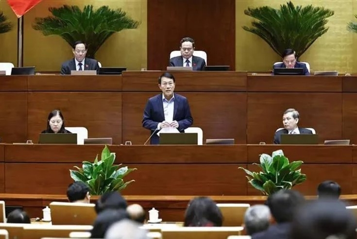 Minister of Public Security, General Luong Tam Quang (standing), delivers his report at the National Assembly's eighth session on November 26.
