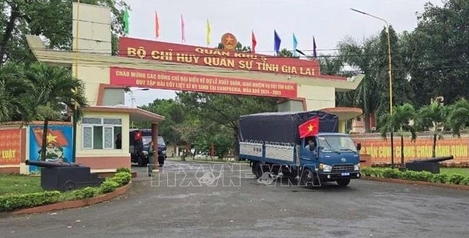 Convoy carrying the K52 search team departs the Gia Lai Military Command headquarters for their mission in Cambodia