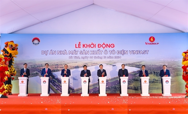 Deputy Prime Minister Tran Hong Ha (fourth from right) and representatives of Vingroup press button to kick off construction of the VinFast e-car factory in Ha Tinh Province. (Photo courtesy of VinFast)