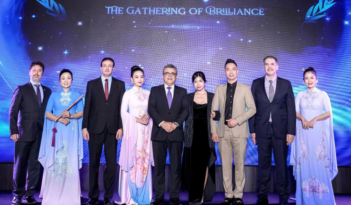 Fashion designer Do Trinh Hoai Nam (third from right) presents his latest Ao Dai collection which draws inspiration from pieces of work created by famous painters around the world.