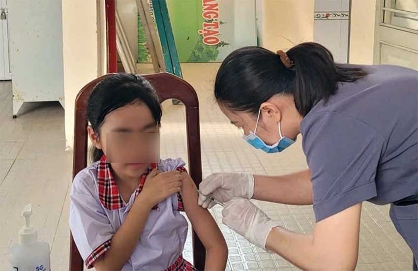 A girl receives a measles shot in Dong Nai