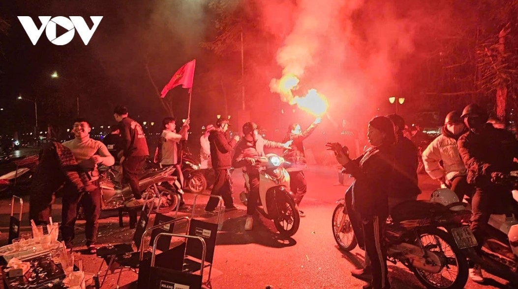 Fans light flares in Hai Phong as they cheer on the Vietnamese national team at the regional tournament.