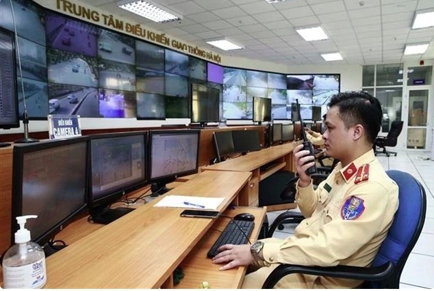 Traffic police officers on duty handling violations through the camera system at the Hanoi Traffic Control Centre.