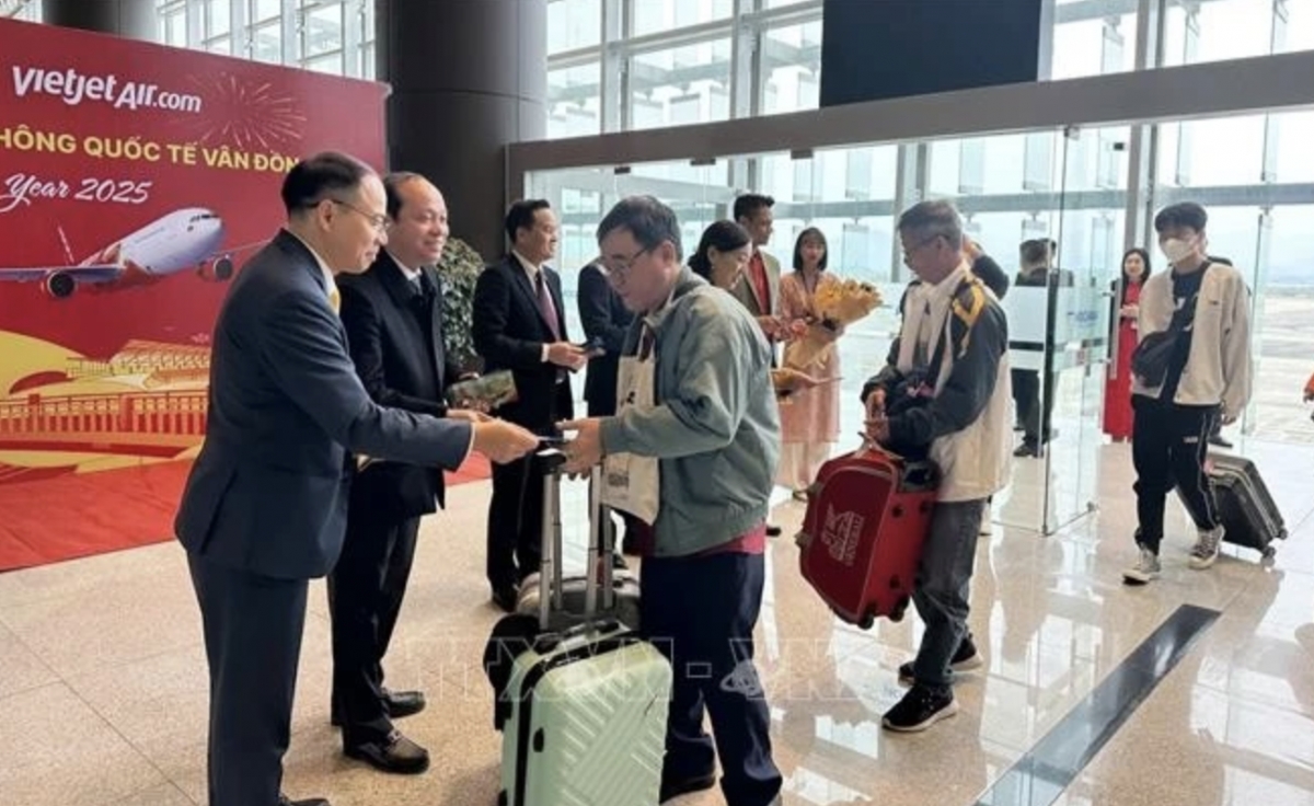 Representatives from Quang Ninh's Van Don district and Tourism Department welcome and give lucky money to visitors at Van Don airport. (Photo: VNA)