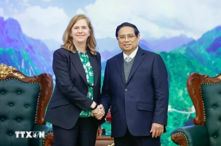 Prime Minister Pham Minh Chinh (R) meets with Lynn Maxwell, Global Chief Commercial Officer at S&amp;P Global Ratings, in Hanoi on February 26.