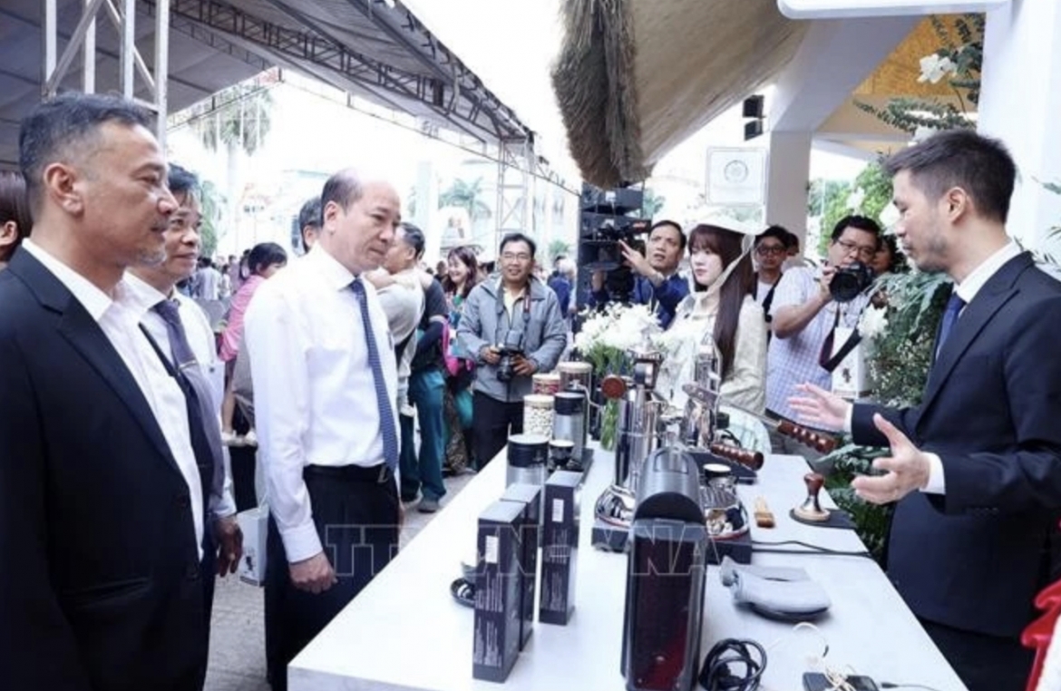 Delegates visit a booth displaying coffee making machinery and equipment at the fair.