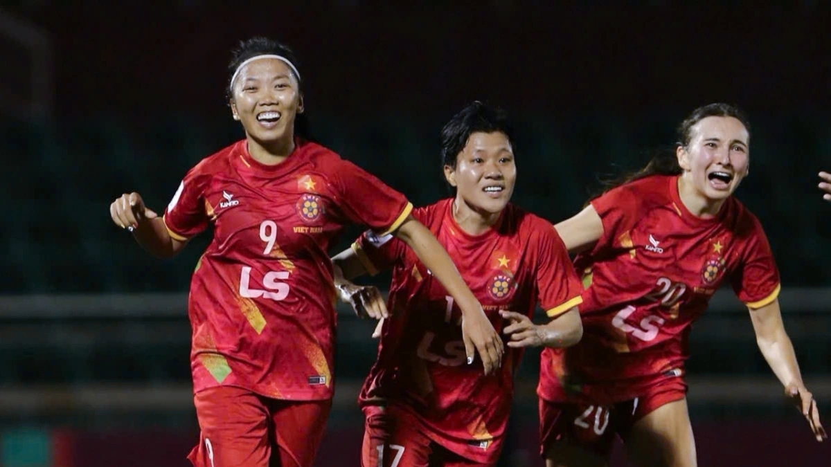 Striker Huynh Nhu and her teammates celebrate their team's stunning victory over Abu Dhabi Country (UAE) in HO Chi Minh City on March 22 evening.