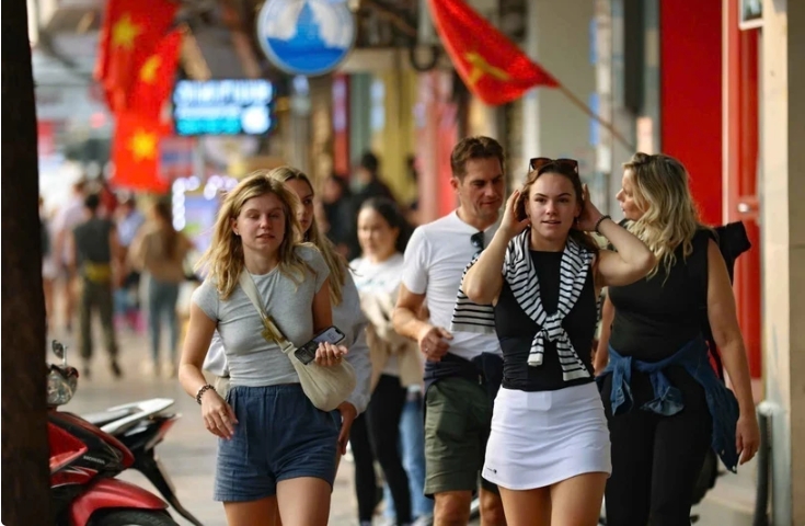 Foreign tourists visit Hanoi's Old Quarter.