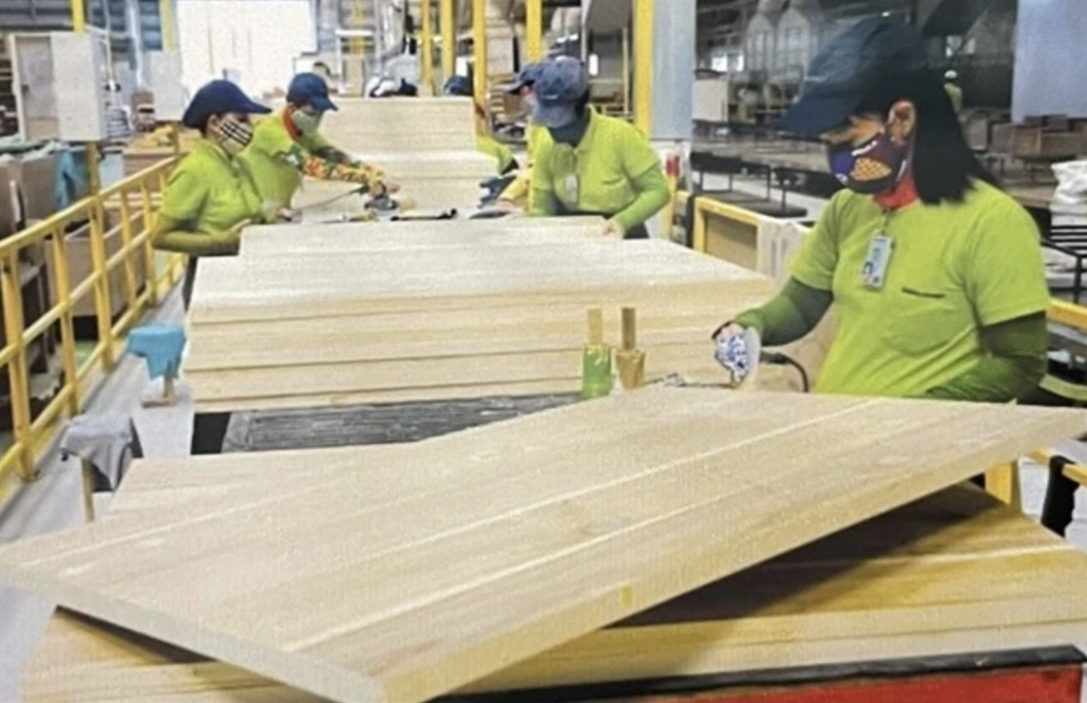 Workers at a factory in the southern province of Binh Duong process wood for export.