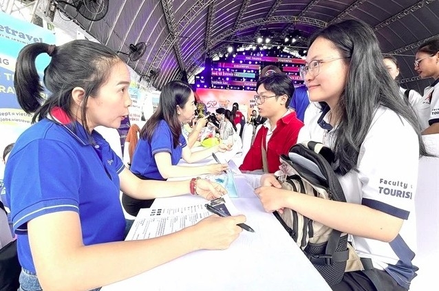 People take part in a job fair in HCM City to seek suitable work.