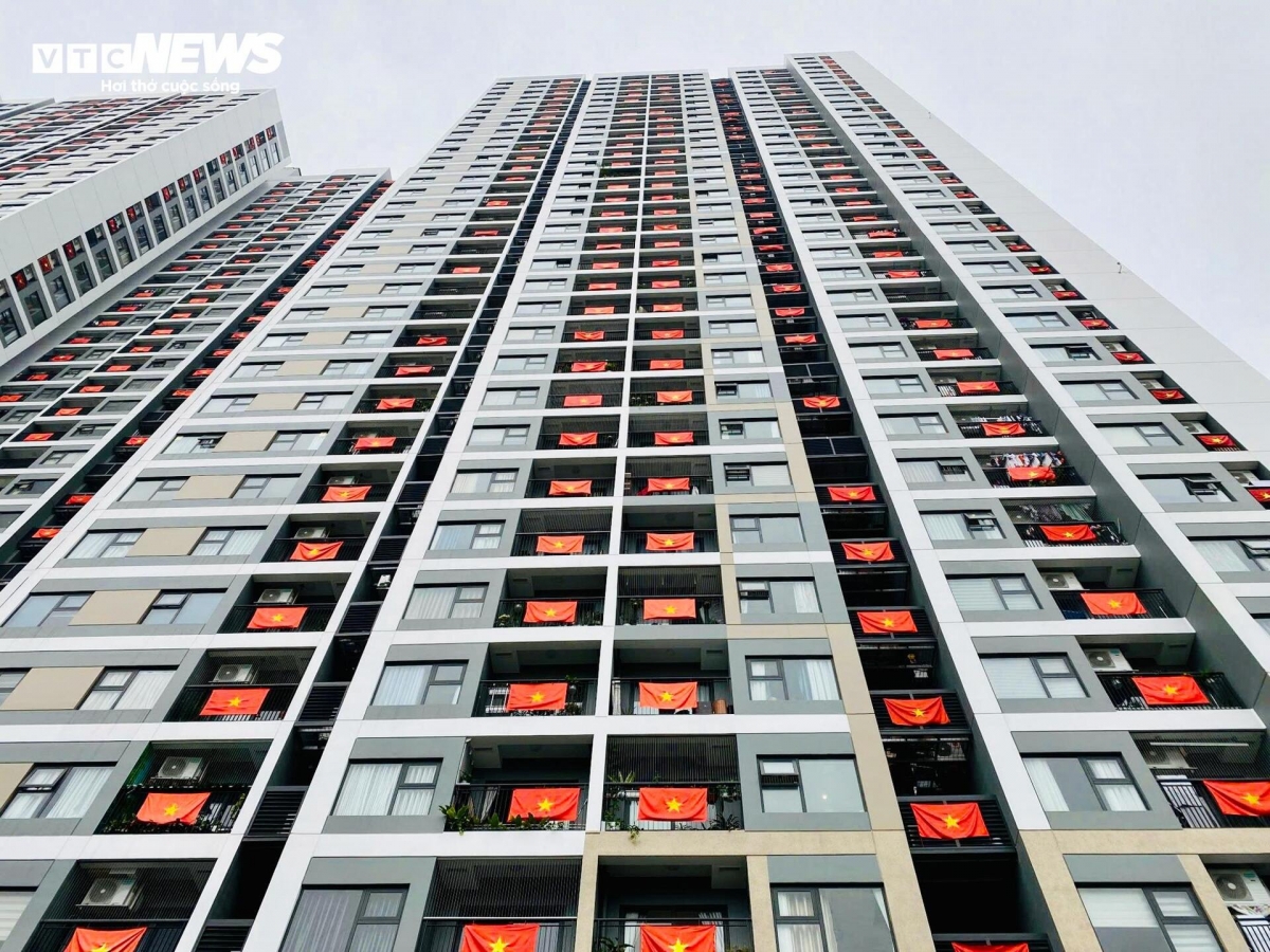 Celebrating 50 years of natinal reunification, residents across high-rise buildings proudly display flags on their balconies.
