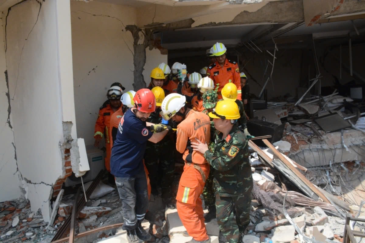 Vietnamese rescue workers in collaboration with colleagues from Myanmar and Turkey bring the survivor from debris on April 2 following the devastating 7.7 magnitude earthquake in Myanmar