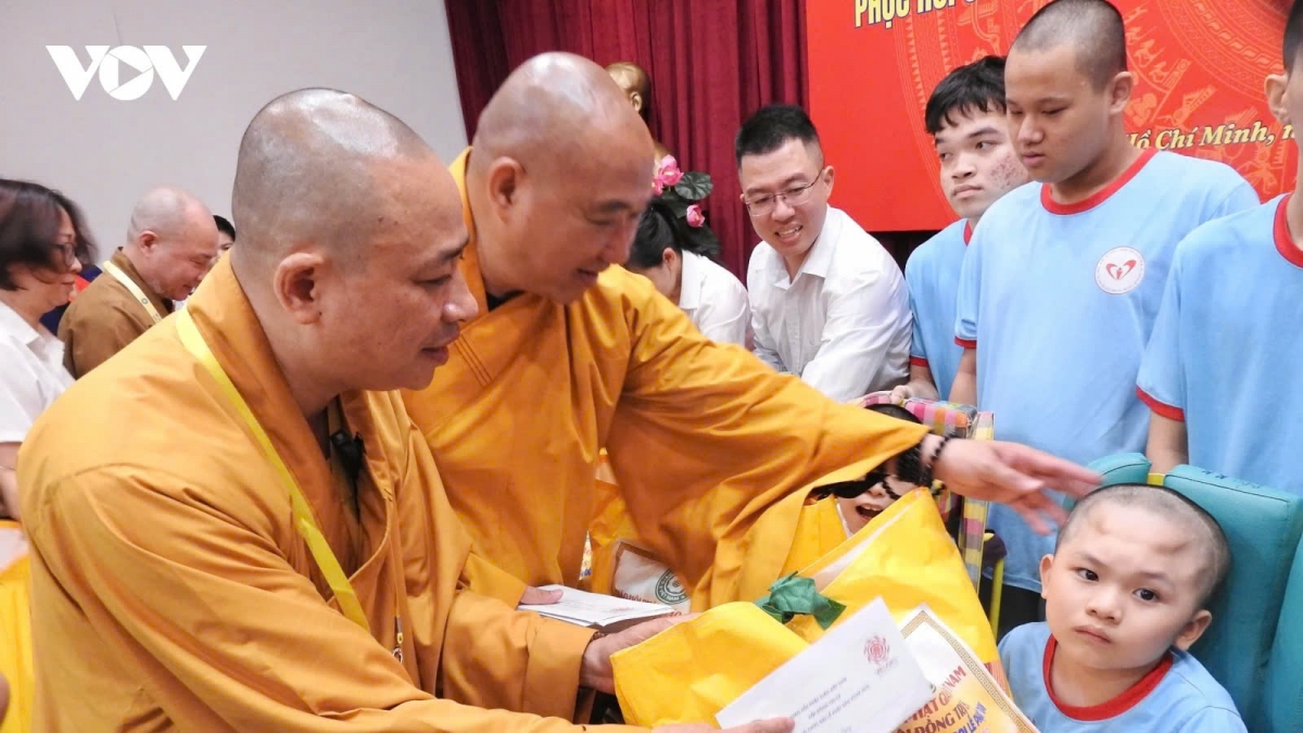Buddhist monks and nuns provide gifts to children with disabilities at the centre
