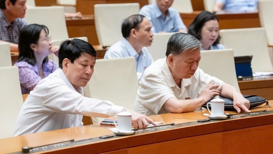 National Assembly deputies press the button approving the draft resolution in Hanoi on May 17