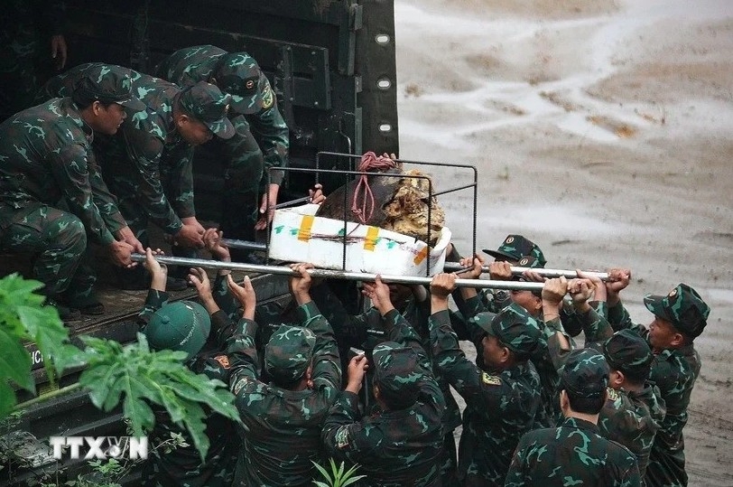 Military personnel prepare for the detonation of unexploded ordnance.