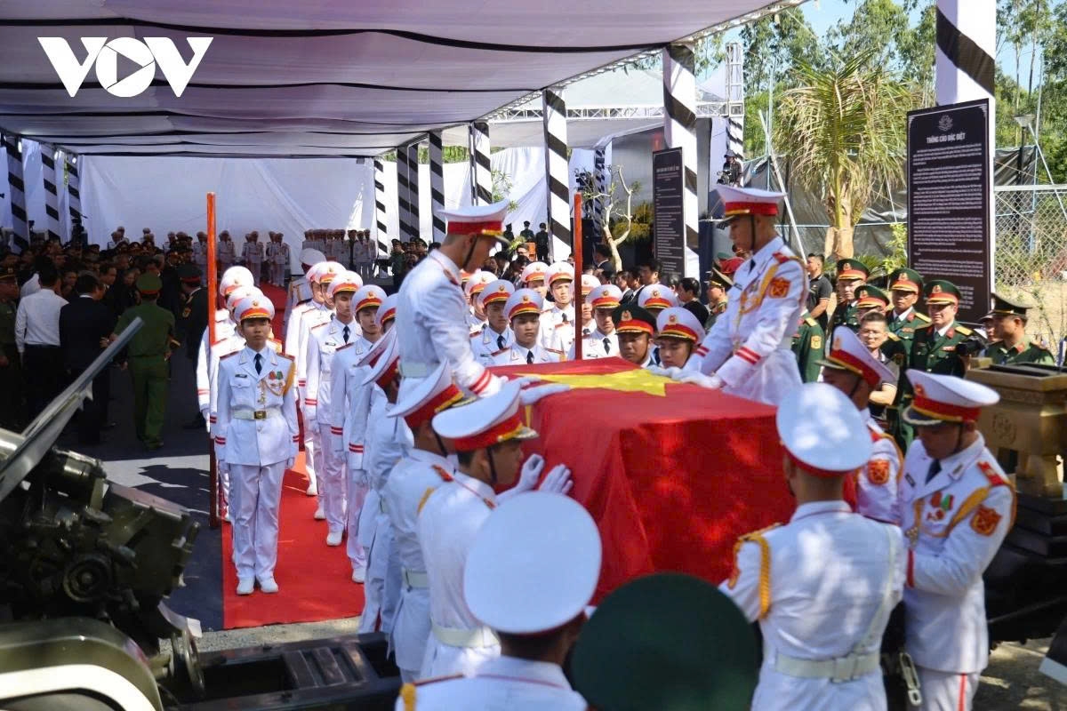 Honour guard members carry the coffin up to the grave site. 