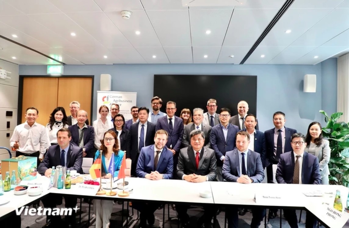 Deputy Minister Tran Thanh Nam (front line, in a red tie) takes a photo with representatives of German associations and businesses at the event