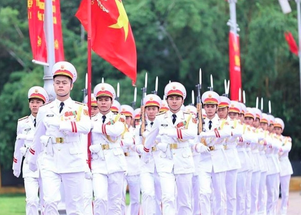 The military victory flag leads the formation, followed by 34 officers representing the first 34 soldiers of the  Vietnam Propaganda Unit of Liberation Army, now the Vietnam People's Army.