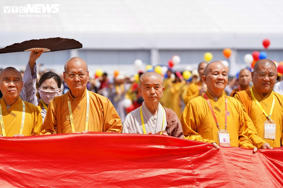 Thousands of Buddhist followers and visitors gather for the solemn flag-raising ceremony