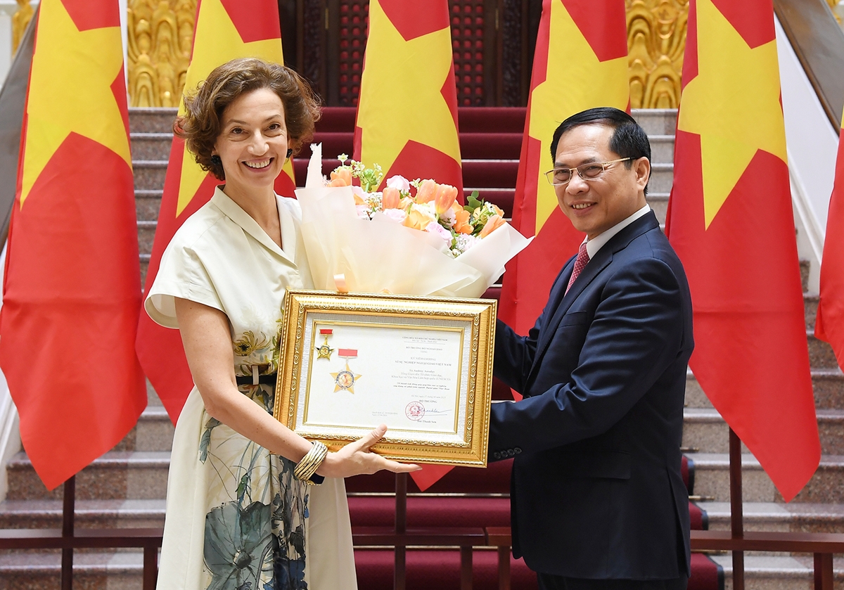 Deputy Prime Minister and Foreign Minister Bui Thanh Son (R) presents Vietnam's diplomatic insignia to UNESCO Director-General Audrey Azoulay in Hanoi on June 28. (Photo: VGP)