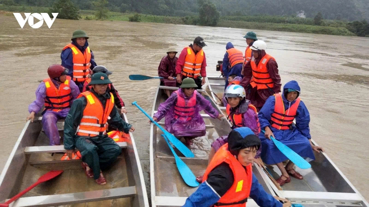 Rescue workers have fanned out to search for two young girls washed away by floodwaters in Quang Binh province
