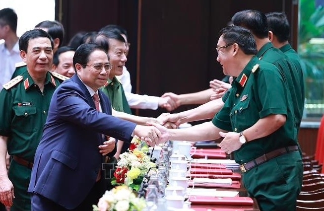 Prime Minister Pham Minh Chinh (front, left) attends the national military-political conference on July 2. (Photo: VNA)