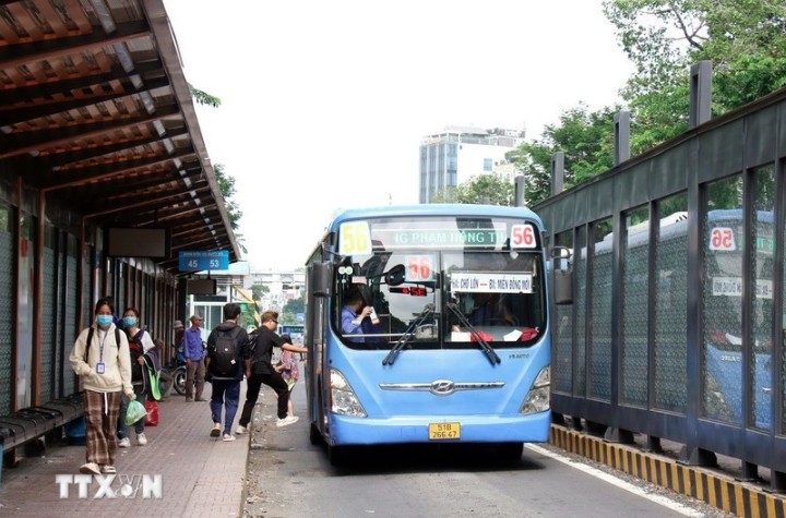 Passengers get on a bus on Ham Nghi street in Ho Chi Minh City.