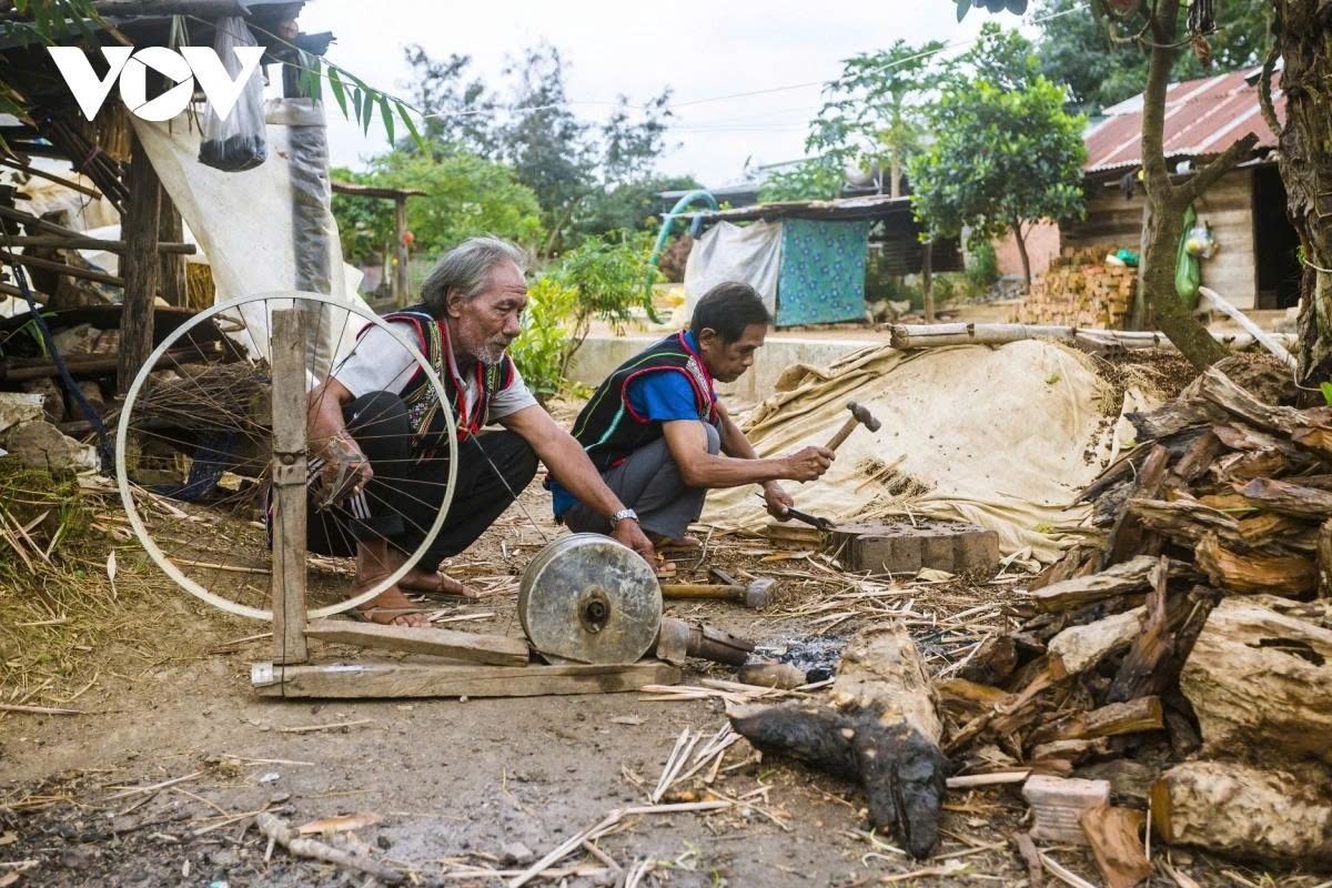 Craftsmen A Lih (with fair hair) and A Hluh want to preserve blacksmithing for future generations