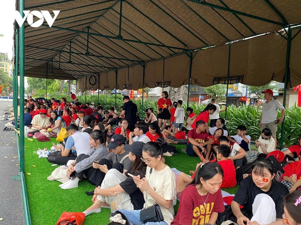 Many people gather inside public tents set up by authorities to take shelter from the rain.