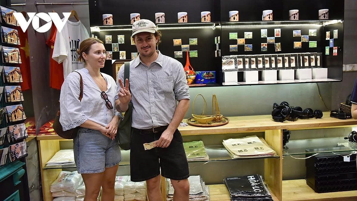 Two tourists from Australia decide to buy souvenirs after visiting the Hoa Lo Prison historical site.