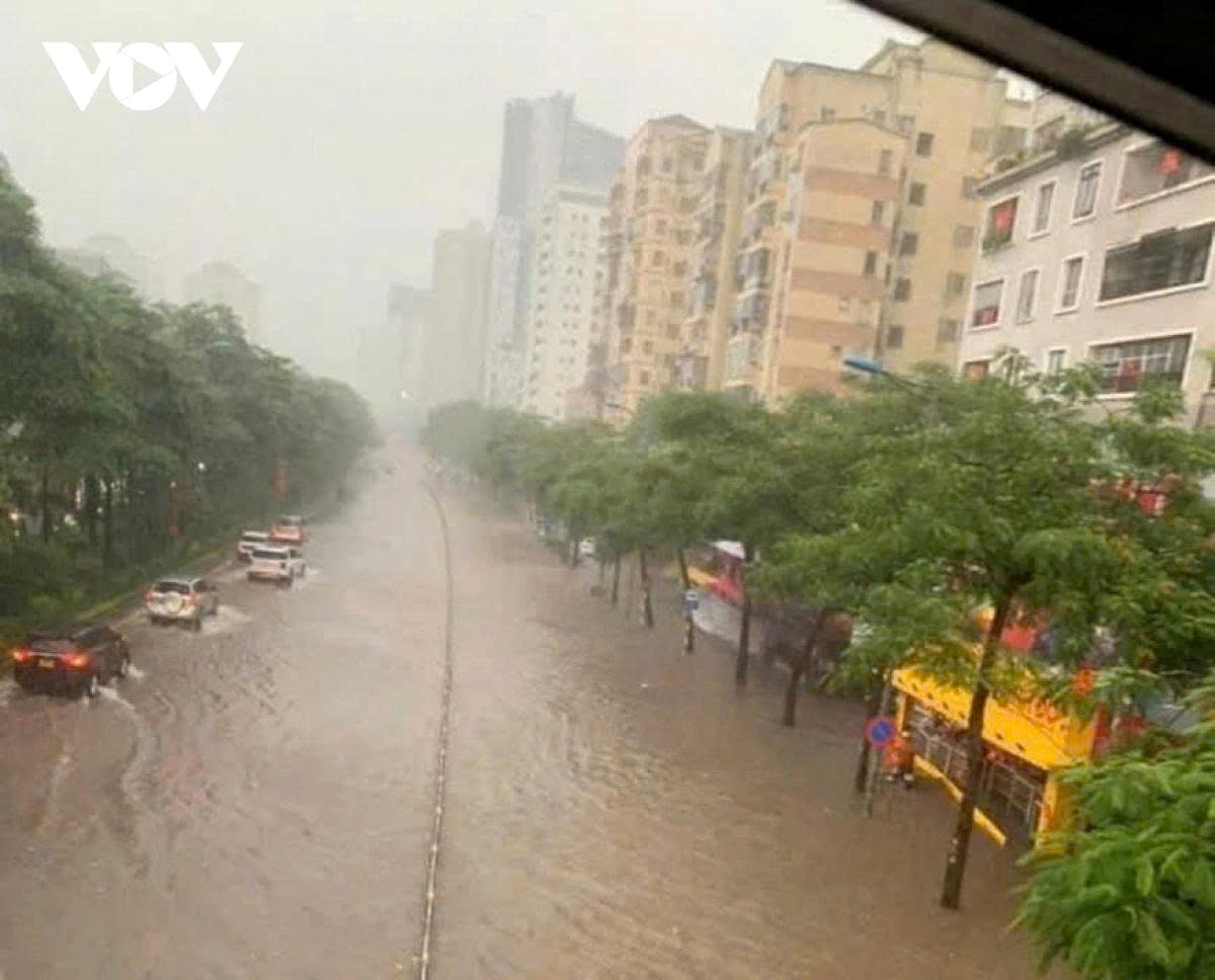 Heavy rain turns Vo Chi Cong Road into a river.