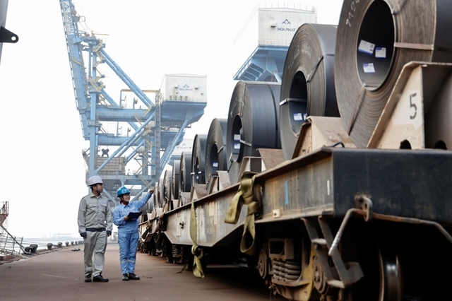 Workers inspect a HRC shipment in a port located in northern Vietnam. (VGP Photo)