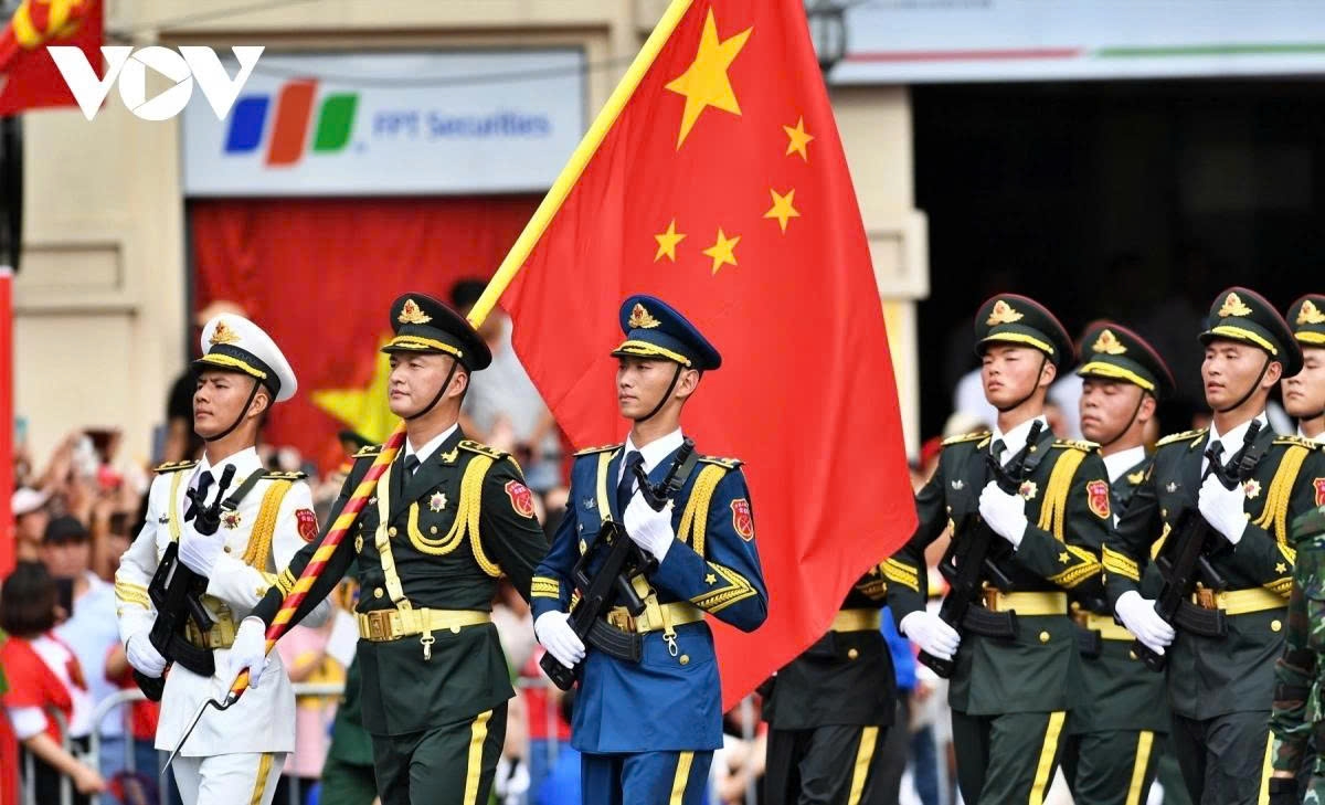 Foreign military contingents march through central Hanoi streets before gathering at August Revolution Square.
