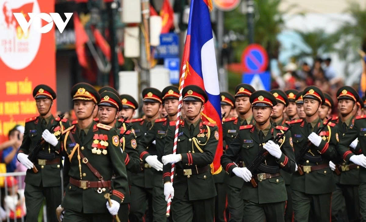 A total of 120 Lao soldiers march through the streets of Hanoi.