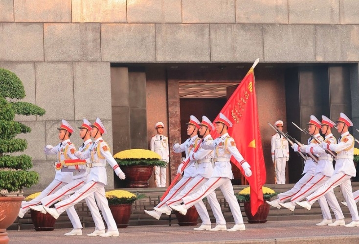 The honour guard march in review past the Ho Chi Minh Mausoleum.