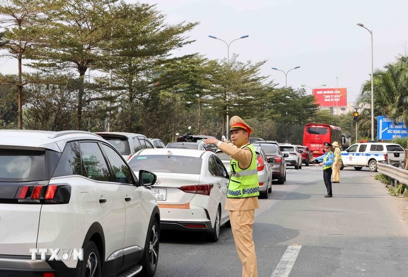 Traffic police direct the vehicle flow at the Phap Van Expressway interchange.
