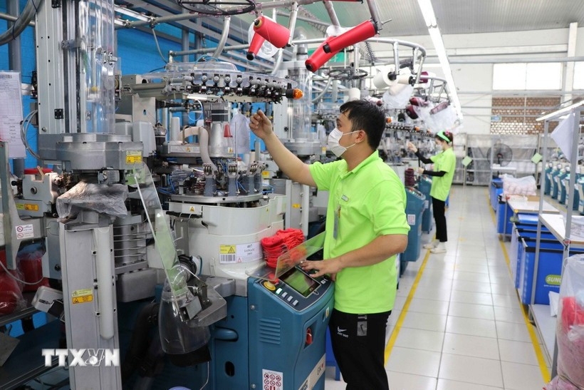 Workers operate machinery at the Sung Hwa Vina factory, a Korean-invested enterprise in Hoa Binh Industrial Park, Tay Ninh province