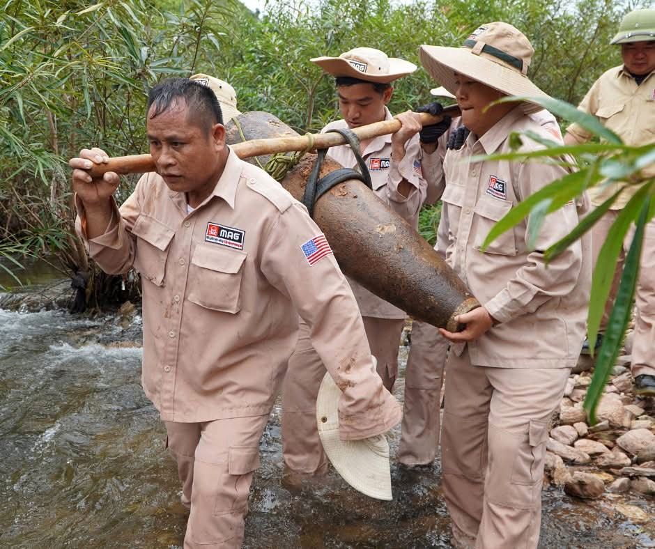 Mines Advisory Group experts move the unexploded wartime bomb to a site for disposal. (Photo: MAG)