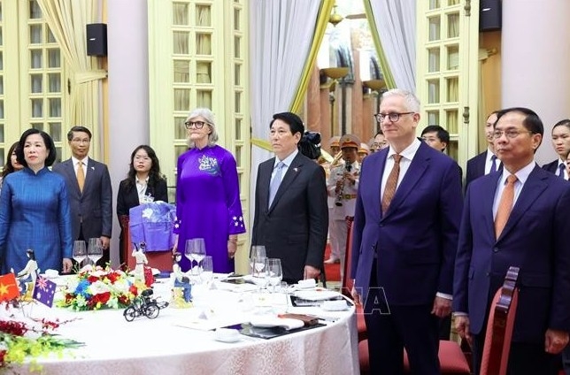 State President Luong Cuong, his spouse, together with Australian Governor-General Sam Mostyn and her spouse and delegates take part in a flag-saluting ceremony at the banquet. (Photo: VNA)